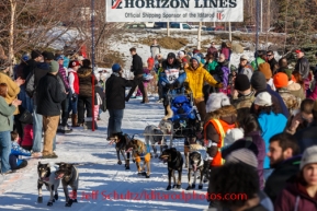 Rookie musher, Elliott Anderson, drives his dog team and IditaRider along a bike/ski trail near the Alaska Native Hospital during the ceremonial start to Iditarod 2014 in Anchorage, Alaska.Iditarod Sled Dog Race 2014PHOTO (c) BY JEFF SCHULTZ/IditarodPhotos.com -- REPRODUCTION PROHIBITED WITHOUT PERMISSION