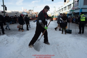 Volunteer trail maintenence crew Jim Lupton shovels snow at the C Street intersection during the ceremonial start of the 2019 Iditarod.Photo by Jeff Schultz/  (C) 2019  ALL RIGHTS RESERVED