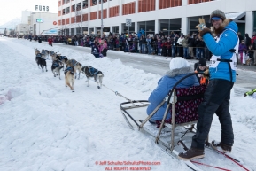 Matthew Failor runs down 4th avenue during the ceremonial start of the 2019 Iditarod in downtown Anchorage, Alaska on Saturday March 2.Photo by Jeff Schultz/  (C) 2019  ALL RIGHTS RESERVED