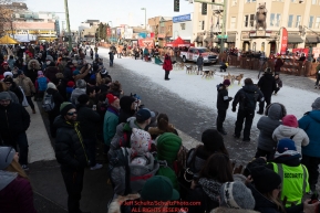 Dog teams line up for their turn to leave the start line on 4th avenue as spectators watch from the sidewalk during the ceremonial start of the 2019 Iditarod on Saturday March 2..Photo by Jeff Schultz/  (C) 2019  ALL RIGHTS RESERVED