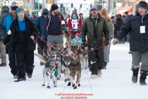 Volunteer dog handlers bring Kristin Bacon team to the start line on 4th avenue during the 2019 ceremonial start of the Iditarod in downtown Anchorage, Alaska on Saturday March 2.Photo by Jeff Schultz/  (C) 2019  ALL RIGHTS RESERVED
