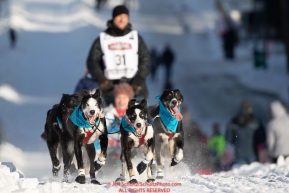 Charlie Benja runs down Cordova Street during the ceremonial start of the 2019 Iditarod in downtown Anchorage, Alaska on Saturday March 2.Photo by Jeff Schultz/  (C) 2019  ALL RIGHTS RESERVED