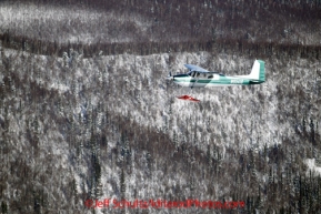 Saturday March 10, 2012  An airplane flies alongside Danny Davidson's (Davidson Aviation) airplane, traveling from Ruby to the Galena checkpoint. Iditarod 2012.