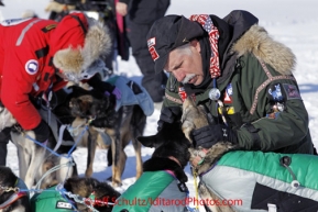 Saturday March 10, 2012 Veterinarian George Stroberg, and other volunteer vets, work with Rick Swenson's dogs. Each time a team pulls into a checkpoint, all dogs are thoroughly examined by professional veterinarians. Iditarod 2012.