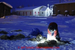 Musher Cim Smyth works with his dogs shortly after his arrival in the early morning at the Kaltag checkpoint on Sunday March 10, 2013.Iditarod Sled Dog Race 2013Photo by Jeff Schultz copyright 2013 DO NOT REPRODUCE WITHOUT PERMISSION