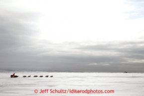 Deedee Jonrowe and her team heads into the Unalakleet checkpoint on Sunday March 10, 2013.Iditarod Sled Dog Race 2013Photo by Jeff Schultz copyright 2013 DO NOT REPRODUCE WITHOUT PERMISSION