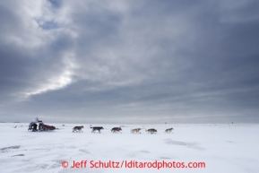 Aliy Zirkle ducks down into a direct headwind shorlty after leaving the Unalakleet checkpoint on Sunday March 10, 2013.Iditarod Sled Dog Race 2013Photo by Jeff Schultz copyright 2013 DO NOT REPRODUCE WITHOUT PERMISSION