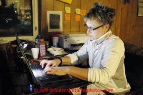 Volunteer Comms Leslie Washburn sends an e-mail at the Kaltag checkpoint on Sunday March 10, 2013.Iditarod Sled Dog Race 2013Photo by Jeff Schultz copyright 2013 DO NOT REPRODUCE WITHOUT PERMISSION