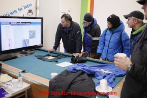 Unalakleet race fans watch the computer screen with musher's GPS positions at the Unalakleet checkpoint on Sunday March 10, 2013.Iditarod Sled Dog Race 2013Photo by Jeff Schultz copyright 2013 DO NOT REPRODUCE WITHOUT PERMISSION