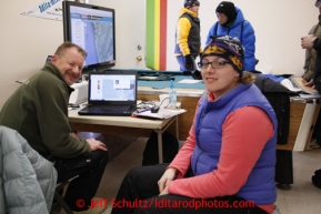 Volunteer Comms Al Wilson (L) and Kelly Neuman man the computer and phones at the Unalakleet checkpoint on Sunday March 10, 2013.Iditarod Sled Dog Race 2013Photo by Jeff Schultz copyright 2013 DO NOT REPRODUCE WITHOUT PERMISSION