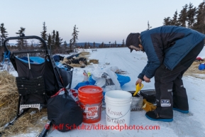 Robert Sorlie prepares to make a fire for hot water at Koyuk on Monday March 10, during the Iditarod Sled Dog Race 2014.PHOTO (c) BY JEFF SCHULTZ/IditarodPhotos.com -- REPRODUCTION PROHIBITED WITHOUT PERMISSION