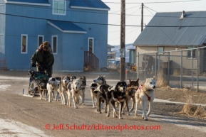 Sonny Lindner drives his team through snow-less Golovin on Monday, March 10, during the Iditarod Sled Dog Race 2014.PHOTO (c) BY JEFF SCHULTZ/IditarodPhotos.com -- REPRODUCTION PROHIBITED WITHOUT PERMISSION