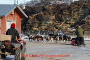 Sonny Lindner moves his dog team along a snow-free road in Golovin on Monday, March 10, during the Iditarod Sled Dog Race 2014. PHOTO (c) BY JEFF SCHULTZ/IditarodPhotos.com -- REPRODUCTION PROHIBITED WITHOUT PERMISSION