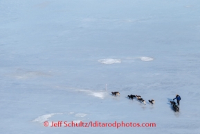 Martin Buser travels along the glare ice between Golovin and White Mountain on Monday, March 10, during the Iditarod Sled Dog Race 2014.PHOTO (c) BY JEFF SCHULTZ/IditarodPhotos.com -- REPRODUCTION PROHIBITED WITHOUT PERMISSION