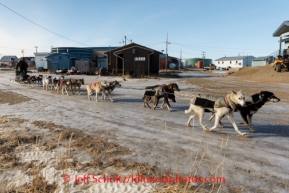 Sonny Lindner moves his dog team along a snow-free road in Golovin on Monday, March 10, during the Iditarod Sled Dog Race 2014. PHOTO (c) BY JEFF SCHULTZ/IditarodPhotos.com -- REPRODUCTION PROHIBITED WITHOUT PERMISSION