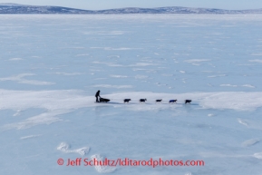 Joar Leifseth Ulsom moves along glare ice enroute to White Mountain shortly after passing through Golovin on Monday, March 10, during the Iditarod Sled Dog Race 2014.PHOTO (c) BY JEFF SCHULTZ/IditarodPhotos.com -- REPRODUCTION PROHIBITED WITHOUT PERMISSION