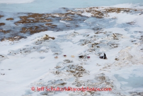 Aaron Burmeister runs off the trail and through rough ice between Golovin and White Mountain on Monday, March 10, during the Iditarod Sled Dog Race 2014.PHOTO (c) BY JEFF SCHULTZ/IditarodPhotos.com -- REPRODUCTION PROHIBITED WITHOUT PERMISSION