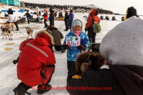 Race fans and media watch as Aliy Zirkle prepares to leave White Mountain after her 8-hour layover on Monday, March 10, during the Iditarod Sled Dog Race 2014.PHOTO (c) BY JEFF SCHULTZ/IditarodPhotos.com -- REPRODUCTION PROHIBITED WITHOUT PERMISSION