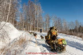 Rick Casillo runs up the road as he leaves the checkpoint of Manley Hot Springs on March 10, 2015.   2015 Iditarod.(C) Jeff Schultz/SchultzPhoto.com - ALL RIGHTS RESERVED   DUPLICATION  PROHIBITED  WITHOUT  PERMISSION