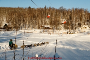 Jodi Bailey crosses the slough shorlty after leaving the checkpoint in Manley Hot Springs on March 10, 2015.  This is the second checkpoint of the 2015 Iditarod.(C) Jeff Schultz/SchultzPhoto.com - ALL RIGHTS RESERVED DUPLICATION  PROHIBITED  WITHOUT  PERMISSION