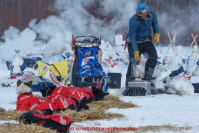 Rookie musher Thomas Waermer from Norway readies his dog food at the Tanana checkpoint in the early evening on March 10, 2015.   2015 Iditarod.(C) Jeff Schultz/SchultzPhoto.com - ALL RIGHTS RESERVED DUPLICATION  PROHIBITED  WITHOUT  PERMISSION