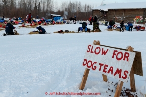 A slow sign sits next to the road where the teams are parked outside the community center at Tanana on March 10, 2015.   2015 Iditarod.(C) Jeff Schultz/SchultzPhoto.com - ALL RIGHTS RESERVED DUPLICATION  PROHIBITED  WITHOUT  PERMISSION