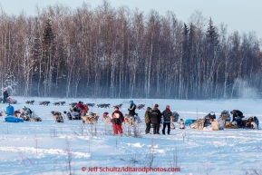 A team leaves Manley Hot Springs checkpoint as other teams rest.  This is the second checkpoint of the 2015 Iditarod.(C) Jeff Schultz/SchultzPhoto.com - ALL RIGHTS RESERVED DUPLICATION  PROHIBITED  WITHOUT  PERMISSION