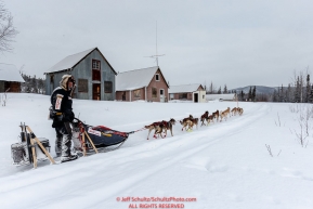 Ed Stielstra runs past old miners cabins on his way to the Ophir Checkpoint on Thursday March 10 during Iditarod 2016.  Alaska.    Photo by Jeff Schultz (C) 2016  ALL RIGHTS RESERVED