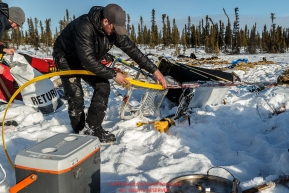 Pete Kaiser changes sled runners at the Cripple checkpoint on Thursday March 10 during Iditarod 2016.  Alaska.    Photo by Jeff Schultz (C) 2016  ALL RIGHTS RESERVED