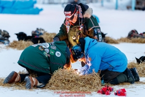 Volunteer Veterinarians Caroline Griffitts and George Stroberg check a dog with Jason Mackey at  the Huslia checkpoint during the 2017 Iditarod on Friday morning March 10, 2017.Photo by Jeff Schultz/SchultzPhoto.com  (C) 2017  ALL RIGHTS RESERVED