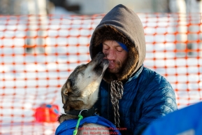 Nicolas Petit gets a kiss from one of his lead dogs