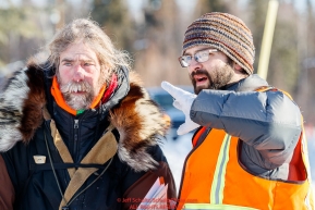 Head Checker Tim Bodony gives directions to Peter Reuter at the Galena checkpoint during the 2017 Iditarod on Friday afternoon March 10, 2017.Photo by Jeff Schultz/SchultzPhoto.com  (C) 2017  ALL RIGHTS RESERVED