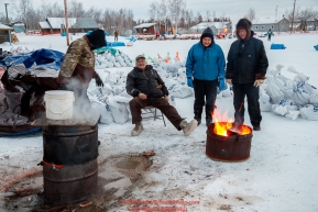 Huslia residents keep water warm for the mushers at the Huslia checkpoint during the 2017 Iditarod on Friday morning March 10, 2017.Photo by Jeff Schultz/SchultzPhoto.com  (C) 2017  ALL RIGHTS RESERVED