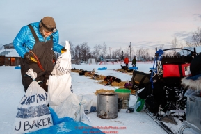 John Baker gets his dog food sorted out at the Huslia checkpoint during the 2017 Iditarod on Friday morning March 10, 2017.Photo by Jeff Schultz/SchultzPhoto.com  (C) 2017  ALL RIGHTS RESERVED