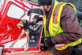 Veterinarian Mike Walker loads a dropped dog to pilot Wes Erb at the ghost-town checkpoint of Iditarod on Saturday, March 10th during the 2018 Iditarod Sled Dog Race -- AlaskaPhoto by Jeff Schultz/SchultzPhoto.com  (C) 2018  ALL RIGHTS RESERVED