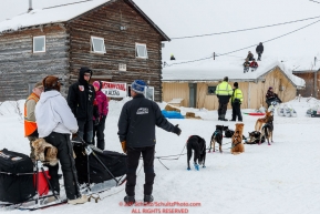 Kids watch from a roof top as Robert Redington arrives at the Kaltag checkpoint on Sunday afternoon March 10th during the 2019 Iditarod Trail Sled Dog Race.Photo by Jeff Schultz/  (C) 2019  ALL RIGHTS RESERVED