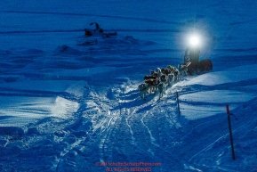 With his headlamp shining the way, Linwood Fiedler runs on the Yukon River as he approaches the Kaltag checkpoint on Sunday  morning March 10th during the 2019 Iditarod Trail Sled Dog Race.Photo by Jeff Schultz/  (C) 2019  ALL RIGHTS RESERVED