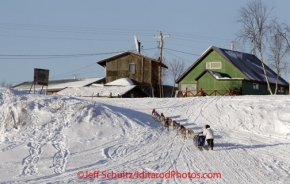 Sunday March 11, 2012   Colleen Robertia runs up the bank of the Yukon River to the Kaltag checkpoint. Iditarod 2012.