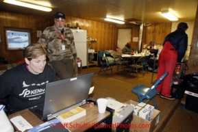 Sunday March 11, 2012  Communications volunteers Lynne Danielson and Pete Semenyna man their post inside the fire hall at the Kaltag checkpoint. Iditarod 2012.