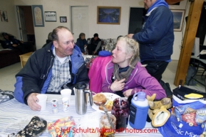 Sunday March 11, 2012  Honorary musher, Dave Olson, shares a meal with a trail weary DeeDee Jonrowe at the Unalakleet checkpoint. Iditarod 2012.