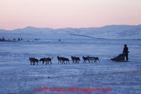 Mike Williams Jr. runs on the trail out of the Unalakleet checkpoint as dawn breaks on Monday March 11, 2013.Iditarod Sled Dog Race 2013Photo by Jeff Schultz copyright 2013 DO NOT REPRODUCE WITHOUT PERMISSION