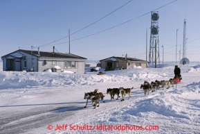 Mike Williams Jr. runs down the main road of Shaktoolikon Monday March 11, 2013.Iditarod Sled Dog Race 2013Photo by Jeff Schultz copyright 2013 DO NOT REPRODUCE WITHOUT PERMISSION