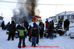 People watch as firefighters try to put out a house fire in the village of Elim on Monday March 11, 2013.Iditarod Sled Dog Race 2013Photo by Jeff Schultz copyright 2013 DO NOT REPRODUCE WITHOUT PERMISSION