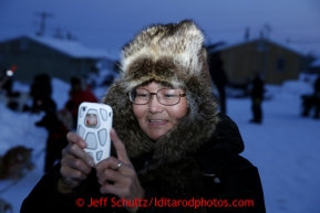 Lily Nylin photographs sled dogs the Elim checkpoint on Monday March 11, 2013.Iditarod Sled Dog Race 2013Photo by Jeff Schultz copyright 2013 DO NOT REPRODUCE WITHOUT PERMISSION