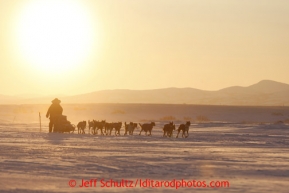 Kelley Griffin runs on the trail at sunrise as she gets closer to the Unalakleet checkpoint on Monday morning March 11, 2013.Iditarod Sled Dog Race 2013Photo by Jeff Schultz copyright 2013 DO NOT REPRODUCE WITHOUT PERMISSION