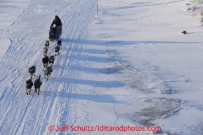 Ramey Smyth team casts long shadows on the trail after leaving the Unalakleet checkpoint on Monday March 11, 2013.Iditarod Sled Dog Race 2013Photo by Jeff Schultz copyright 2013 DO NOT REPRODUCE WITHOUT PERMISSION