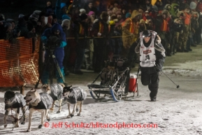 Dallas Seavey runs into the finish chute to win the 2014 Iditarod in record time of 8 days 13 hours 4 minutes and 19 seconds in Nome on Tuesday, March 11, during the Iditarod Sled Dog Race 2014.PHOTO (c) BY JEFF SCHULTZ/IditarodPhotos.com -- REPRODUCTION PROHIBITED WITHOUT PERMISSION