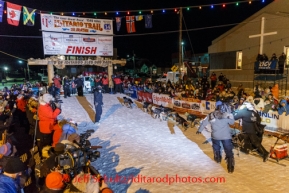 Dallas Seavey runs under the burl arch finish line in Nome on Tuesday, March 11, to win the Iditarod Sled Dog Race 2014.PHOTO (c) BY JEFF SCHULTZ/IditarodPhotos.com -- REPRODUCTION PROHIBITED WITHOUT PERMISSION