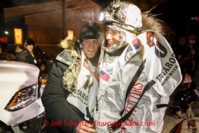 2014 Iditarod champion Dallas Seavey is congratulated by second place finisher Aliy Zirkle at the finish line as they finished just minutes apart in Nome on Tuesday, March 11, during the Iditarod Sled Dog Race 2014.PHOTO (c) BY JEFF SCHULTZ/IditarodPhotos.com -- REPRODUCTION PROHIBITED WITHOUT PERMISSION