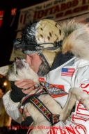 Aliy Zirkle holds up her lead dog Quito shortly after finishing in second place for the 2014 Iditarod in Nome on Tuesday, March 11, during the Iditarod Sled Dog Race 2014.PHOTO (c) BY JEFF SCHULTZ/IditarodPhotos.com -- REPRODUCTION PROHIBITED WITHOUT PERMISSION